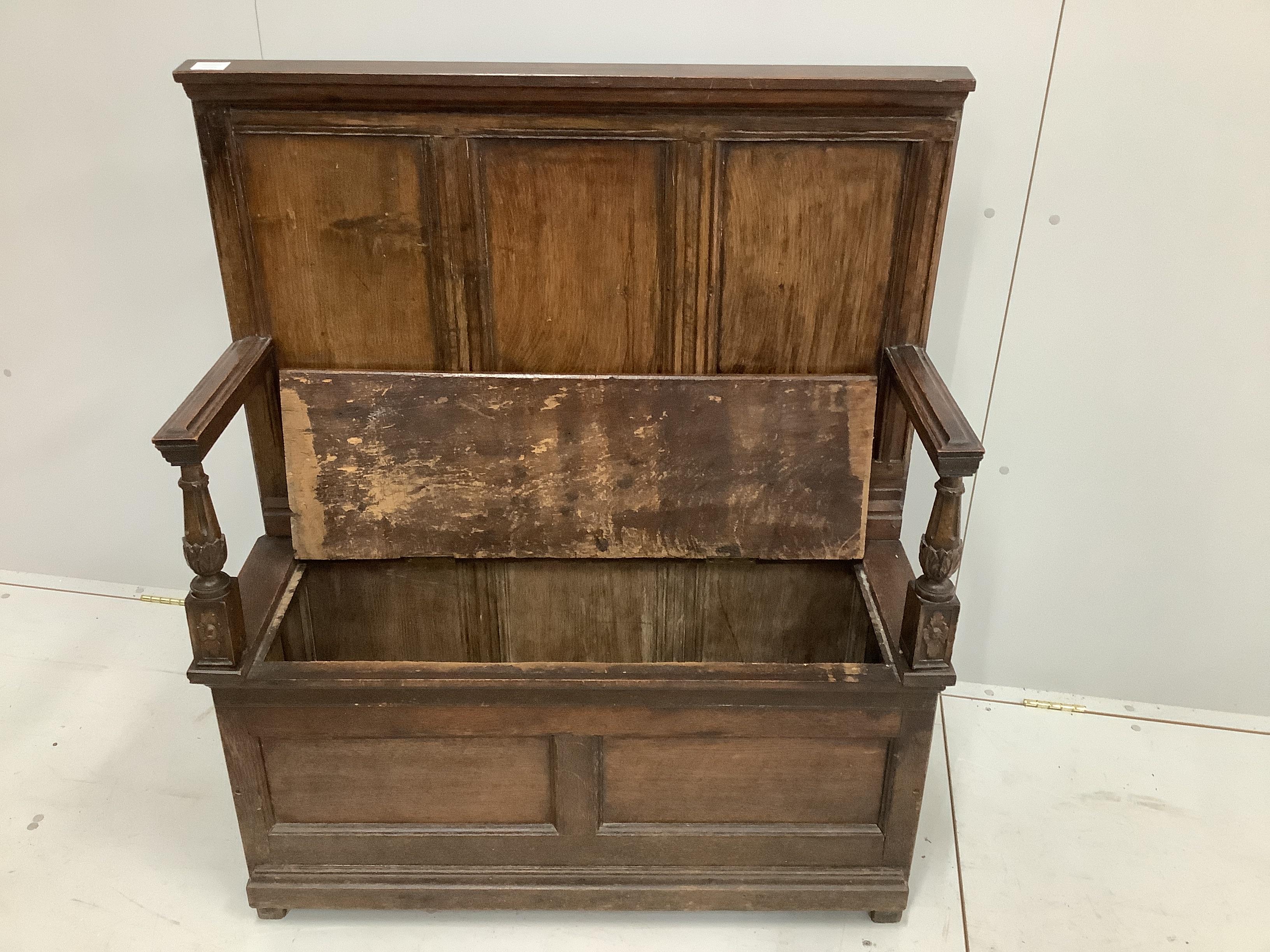 A small panelled oak box settle, width 96cm, depth 34cm, height 114cm